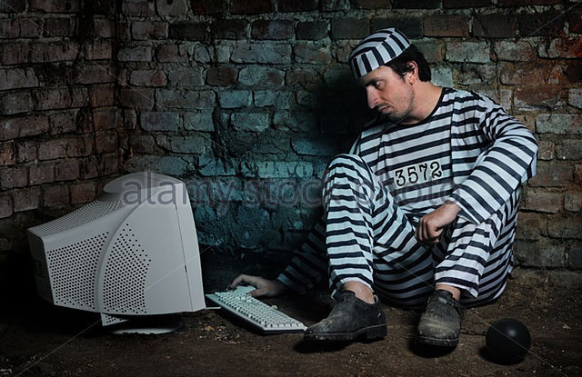 prisoner-in-a-dark-cell-working-with-computer-bb5jd6-1492165883297.jpg