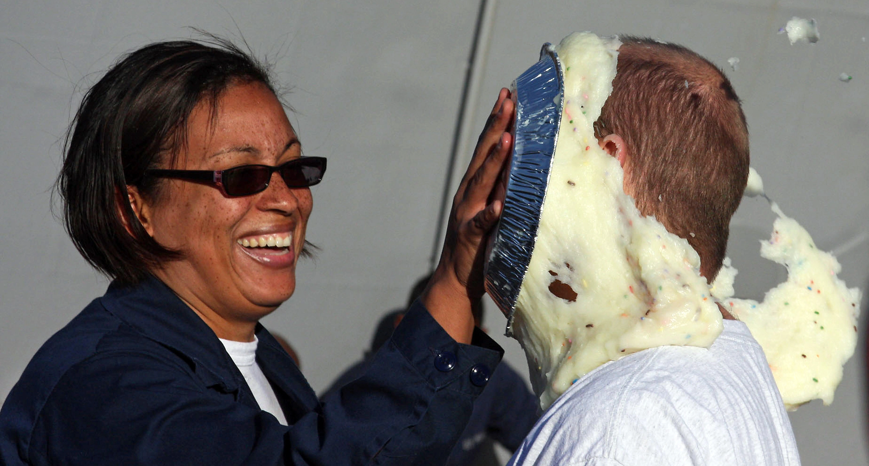 US_Navy_080210-N-9607S-274_Fire_Controlman_1st_Class_Natalie_Stein_throws_a_pie_at_her_boss,_...webp