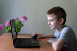 smiling-schoolboy-sitting-at-a-laptop_134398-7401.jpg